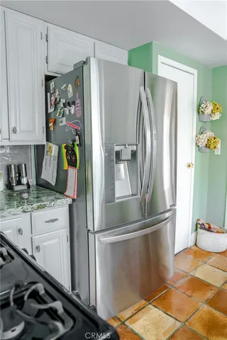 a kitchen with stainless steel appliances a refrigerator and cabinets