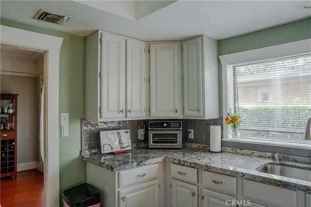 a kitchen with granite countertop a sink and a window