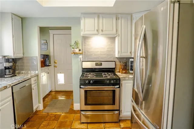 a kitchen with granite countertop a sink and a window