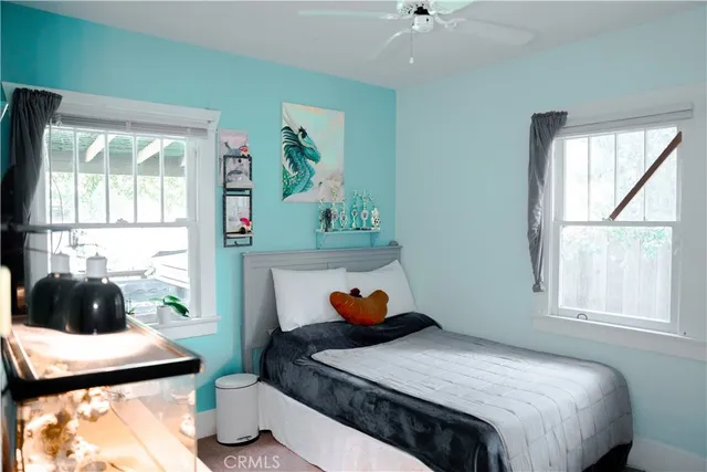 a bathroom with a granite countertop sink toilet and shower curtains