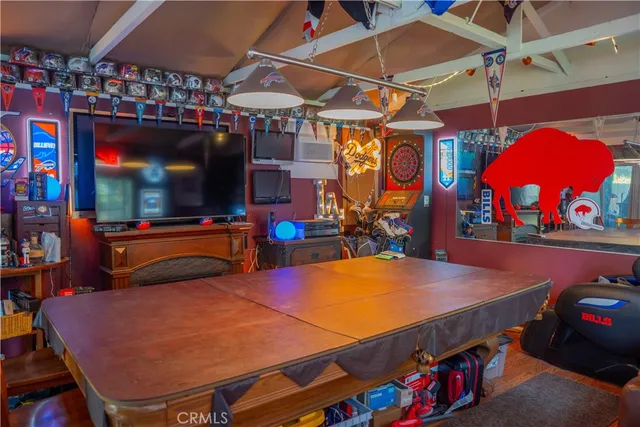 an aerial view of a residential houses with yard