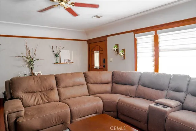 a living room with furniture a fireplace and a large window