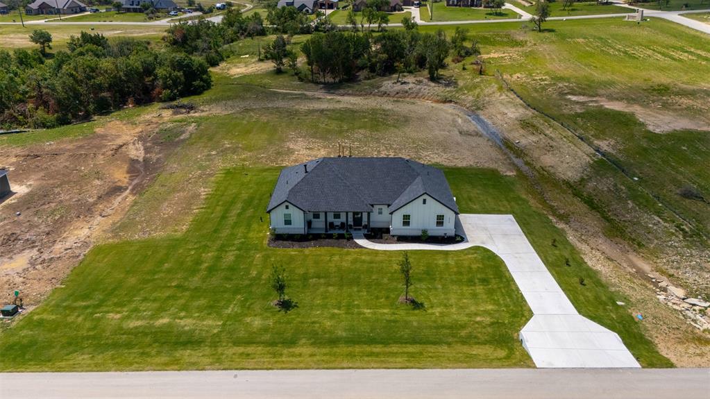 2004 Willy Dilly Road Springtown, TX 76082 - Photo 37 of 40 Newly constructed single-story residence with a dark shingle roof and light-colored siding