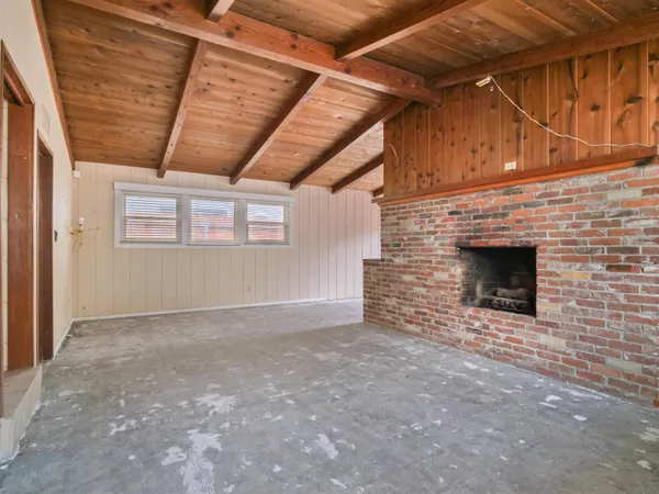 a view of an empty room with a fireplace