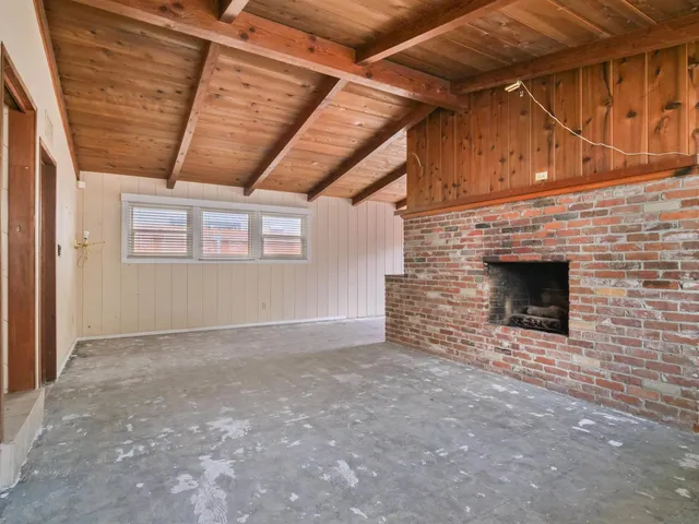a view of an empty room with a fireplace