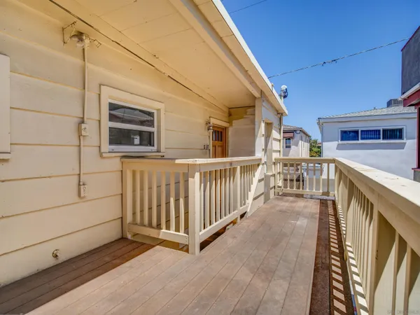 a view of a house with wooden deck