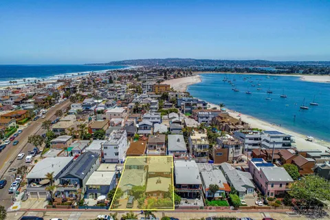 an aerial view of a city with ocean view
