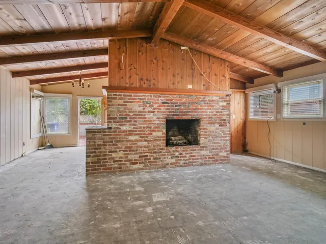 a view of empty room with a fireplace