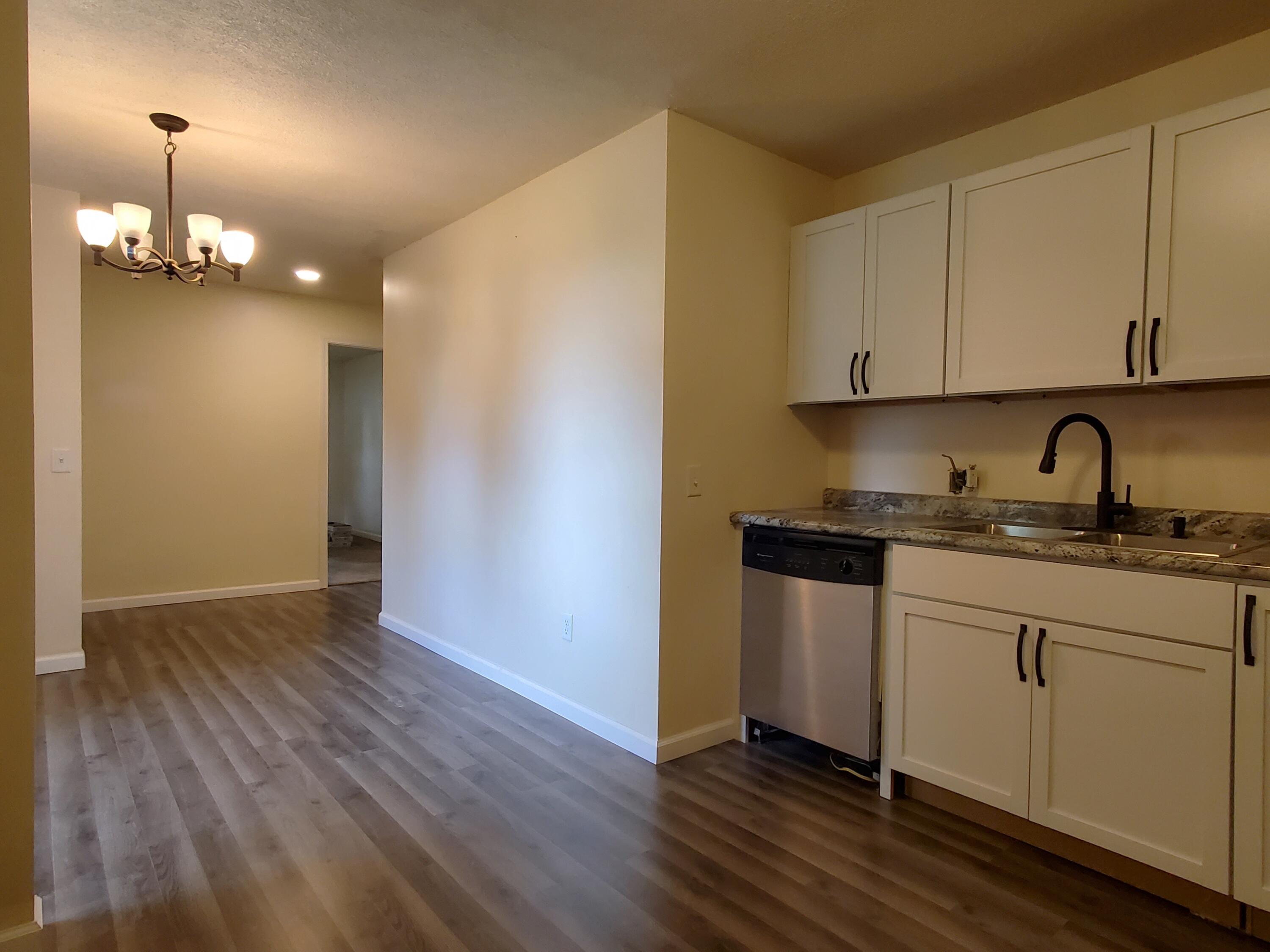 218 West Allen Street Kentland, IN 47951 - Photo 6 of 11 a kitchen with granite countertop a sink cabinets and wooden floor