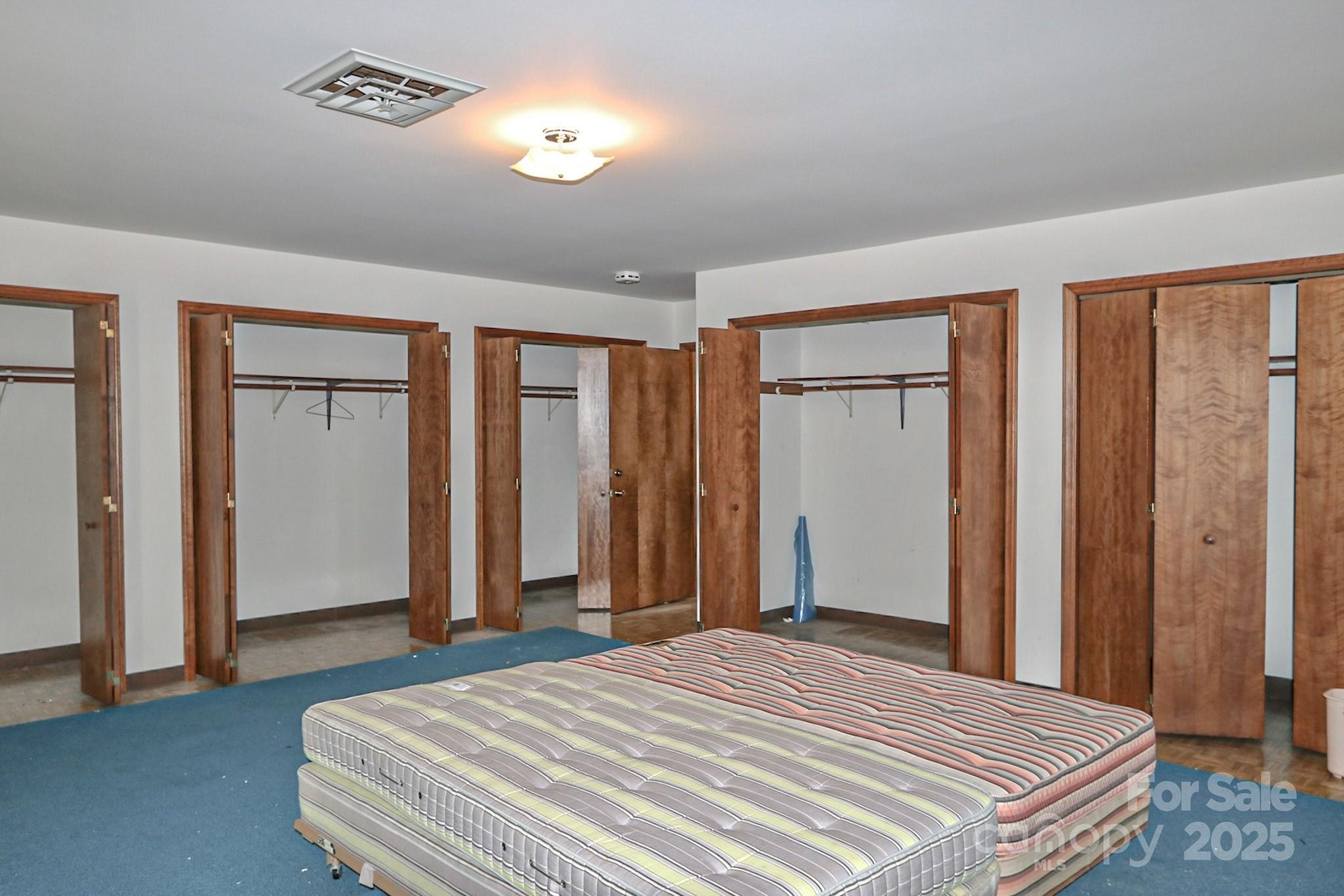 5313 Friendship Circle Road East Bend, NC 27018 - Photo 30 of 48 a bedroom with a bed and a chandelier