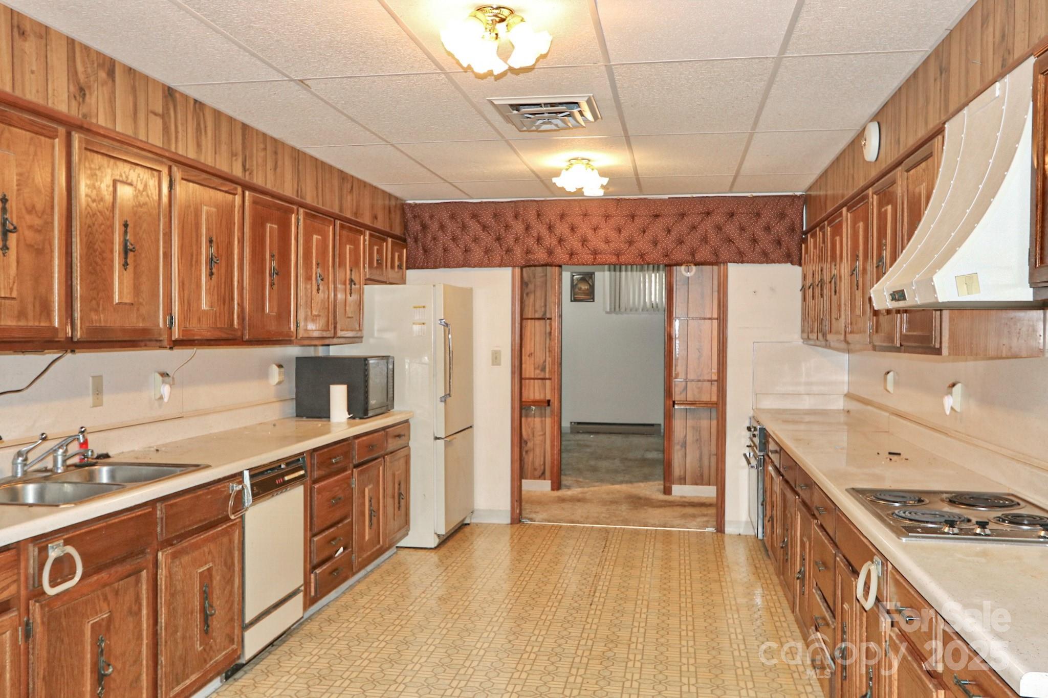 5313 Friendship Circle Road East Bend, NC 27018 - Photo 7 of 48 a kitchen with stainless steel appliances a refrigerator a sink and wooden cabinets