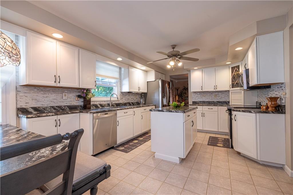 2174 Ramsey Road Monroeville, PA 15146 - Photo 12 of 44 a kitchen with cabinets stainless steel appliances a sink and a counter top space