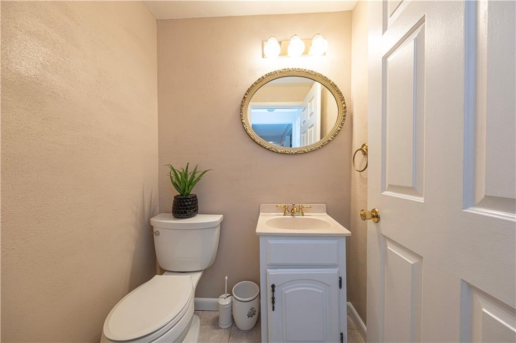 2174 Ramsey Road Monroeville, PA 15146 - Photo 16 of 44 a bathroom with a toilet a sink and a mirror