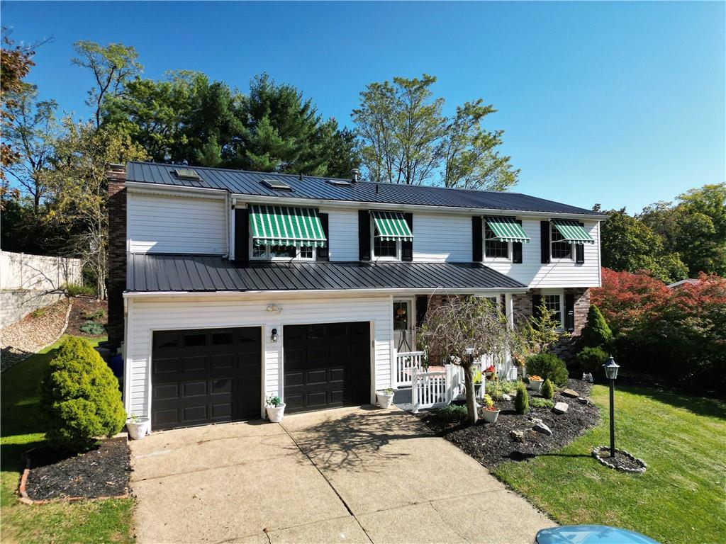 2174 Ramsey Road Monroeville, PA 15146 - Photo 2 of 44 a front view of a house with a garden and trees