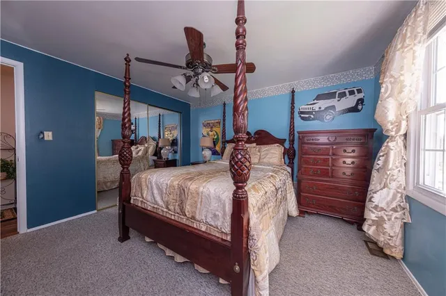 a spacious bedroom with a bed and a chandelier