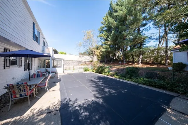 a view of a house with a yard and tree