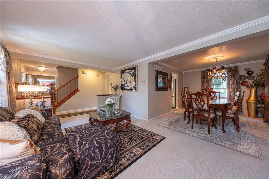 2174 Ramsey Road Monroeville, PA 15146 - Photo 6 of 44 a living room with furniture a dining table and chairs with wooden floor