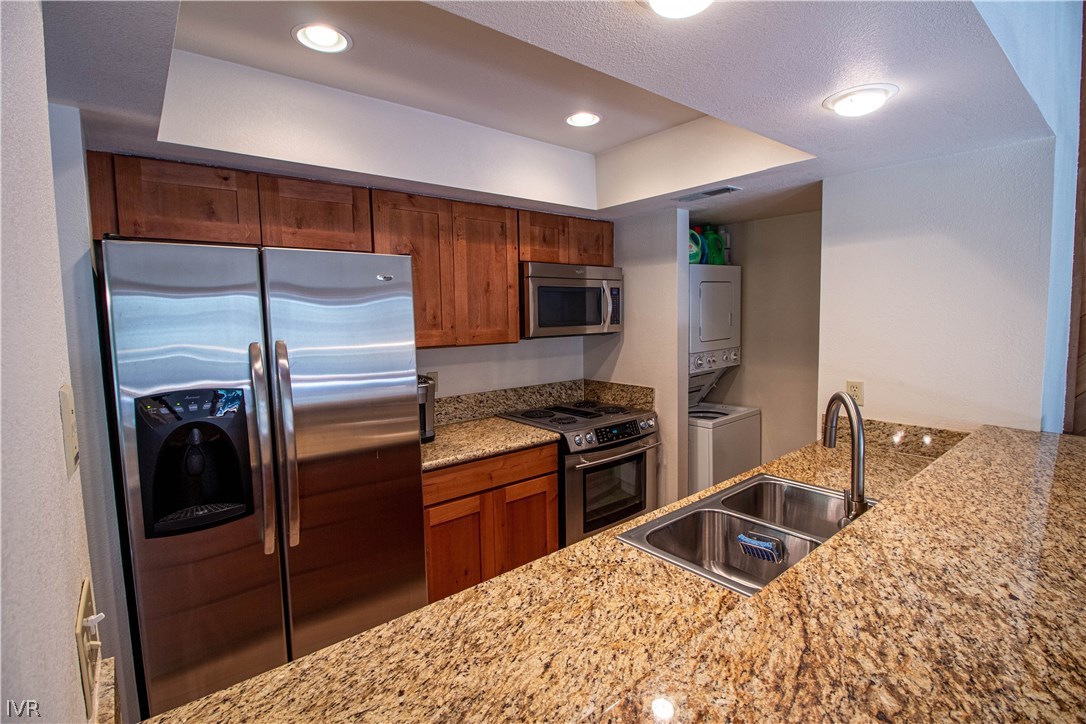 908 Harold Drive, Unit 23 Incline Village, NV 89451 - Photo 4 of 14 a kitchen with stainless steel appliances granite countertop a sink stove and refrigerator