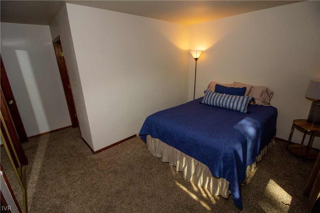 908 Harold Drive, Unit 23 Incline Village, NV 89451 - Photo 6 of 14 a view of a bedroom with a bed and wooden floor