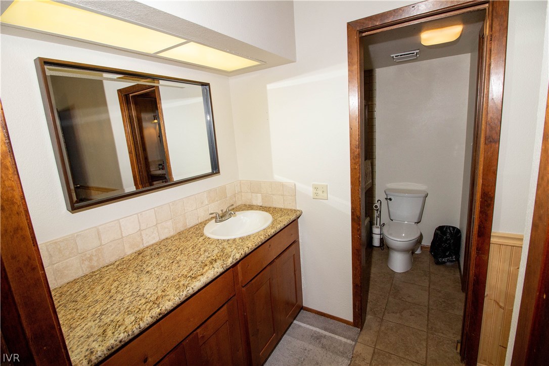 908 Harold Drive, Unit 23 Incline Village, NV 89451 - Photo 9 of 14 a bathroom with a granite countertop sink and a mirror