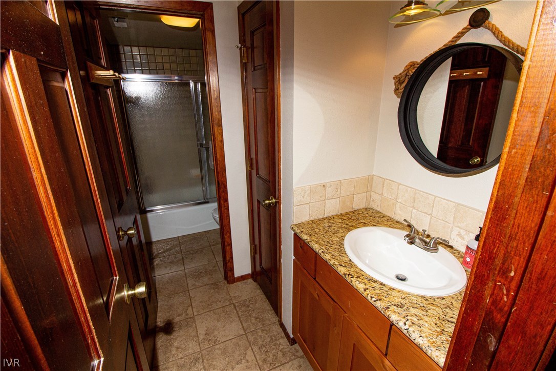 908 Harold Drive, Unit 23 Incline Village, NV 89451 - Photo 10 of 14 a bathroom with a sink a mirror a bathtub and shower