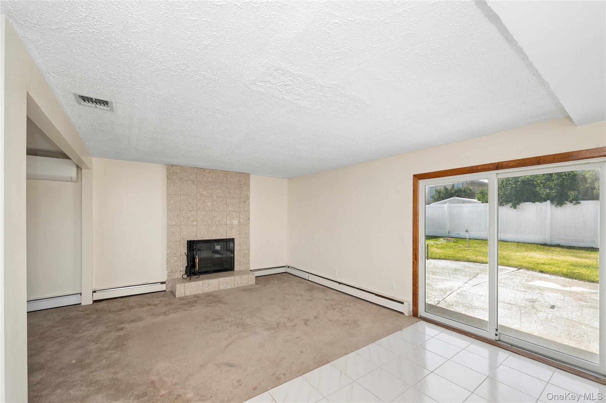2625 Riverside Drive Wantagh, NY 11793 - Photo 18 of 20 an empty room with fireplace and a window