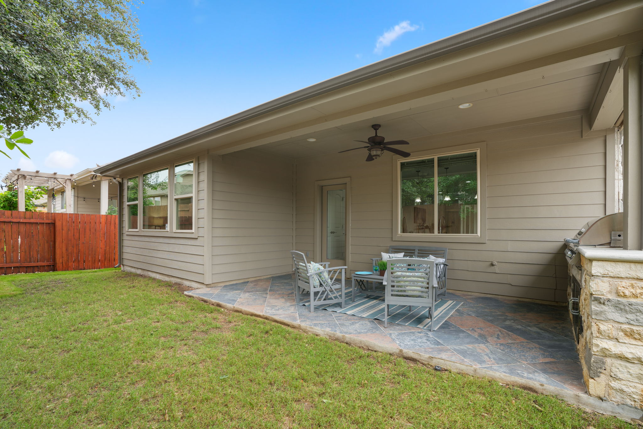 440 Cherokee Rose Circle Georgetown, TX 78626 - Photo 31 of 39 An inviting covered patio featuring a built-in outdoor grill offers seamless indoor-outdoor living.