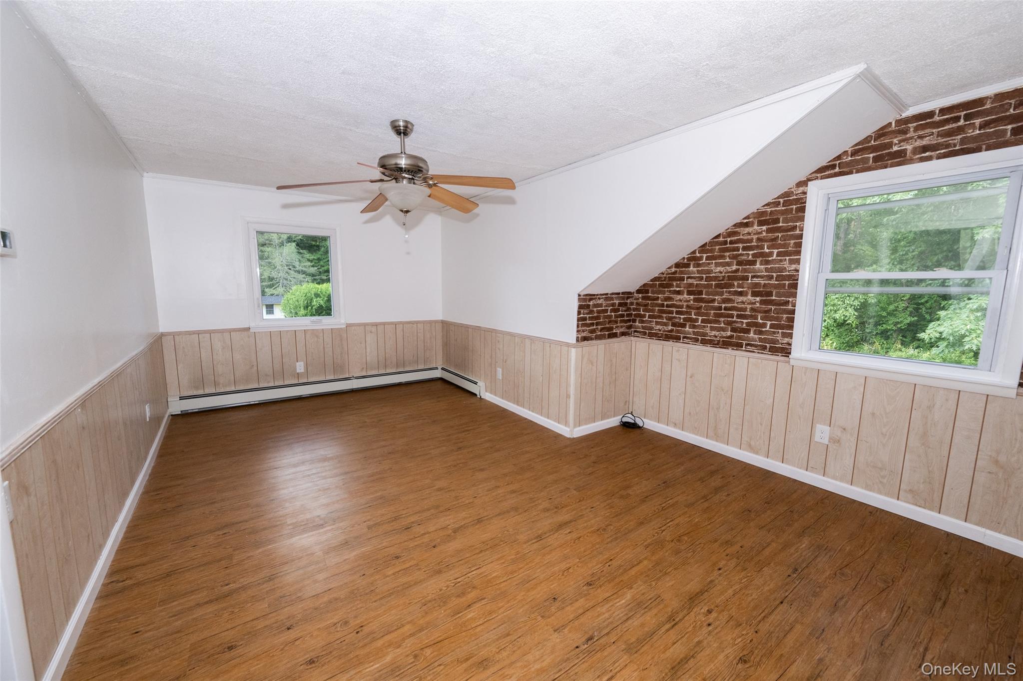 136 Foggintown Road Brewster, NY 10509 - Photo 34 of 50 an empty room with wooden floor and windows