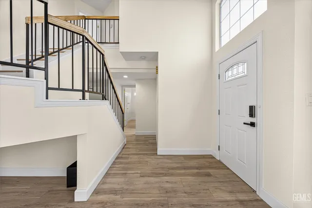 a view of entryway and hall with wooden floor