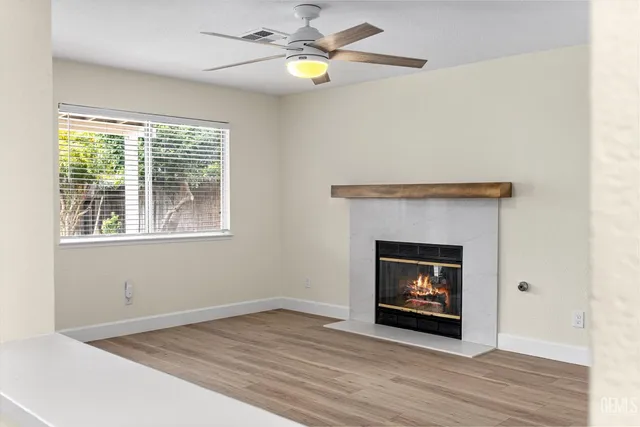 a kitchen with granite countertop a dining table chairs and white cabinets