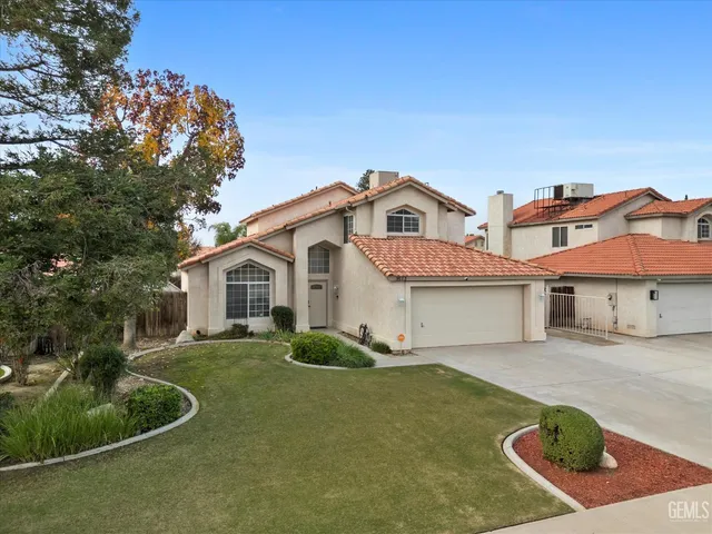 an aerial view of residential houses with outdoor space and city view