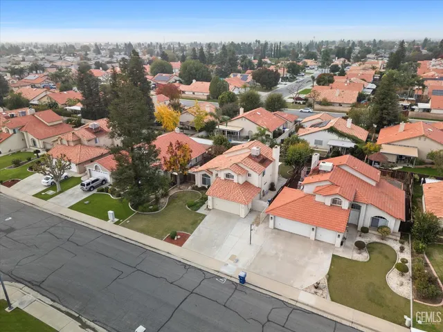 an aerial view of a multi story residential apartment building with yard