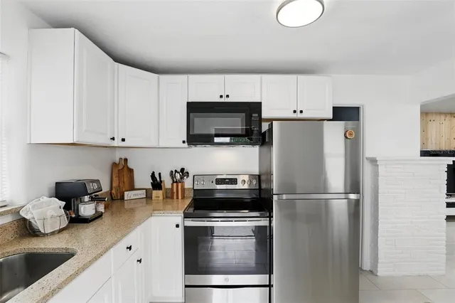 a kitchen with a refrigerator stove and microwave
