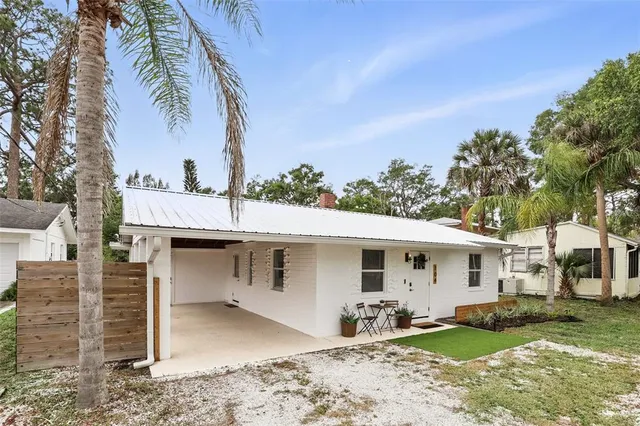 a view of a house with backyard space and tree