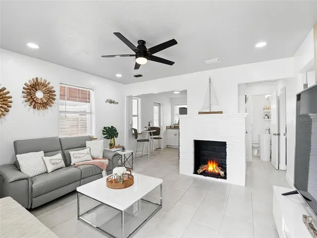 a living room with furniture a rug and a fireplace