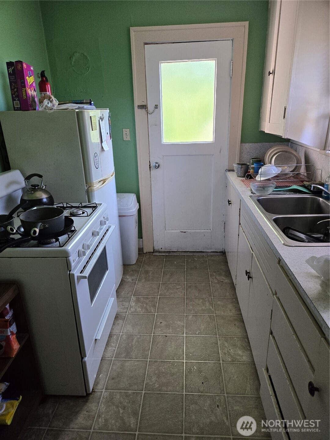 500 Gladstone Street Bellingham, WA 98225 - Photo 16 of 16 a kitchen with a stove a sink and a refrigerator