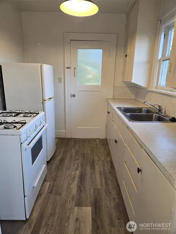 a kitchen with a sink stove and cabinets