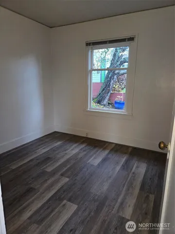 a view of room with window and hardwood floor
