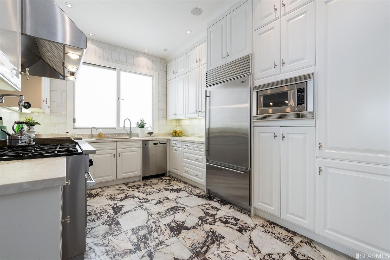 135 Sea Cliff Avenue San Francisco, CA 94121 - Photo 19 of 69 a kitchen with a sink refrigerator and cabinets