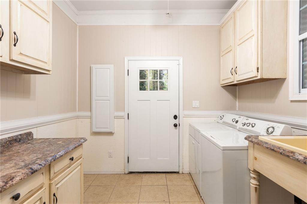 3653 North Street Northwest Duluth, GA 30096 - Photo 18 of 21 a utility room with cabinets washer and dryer
