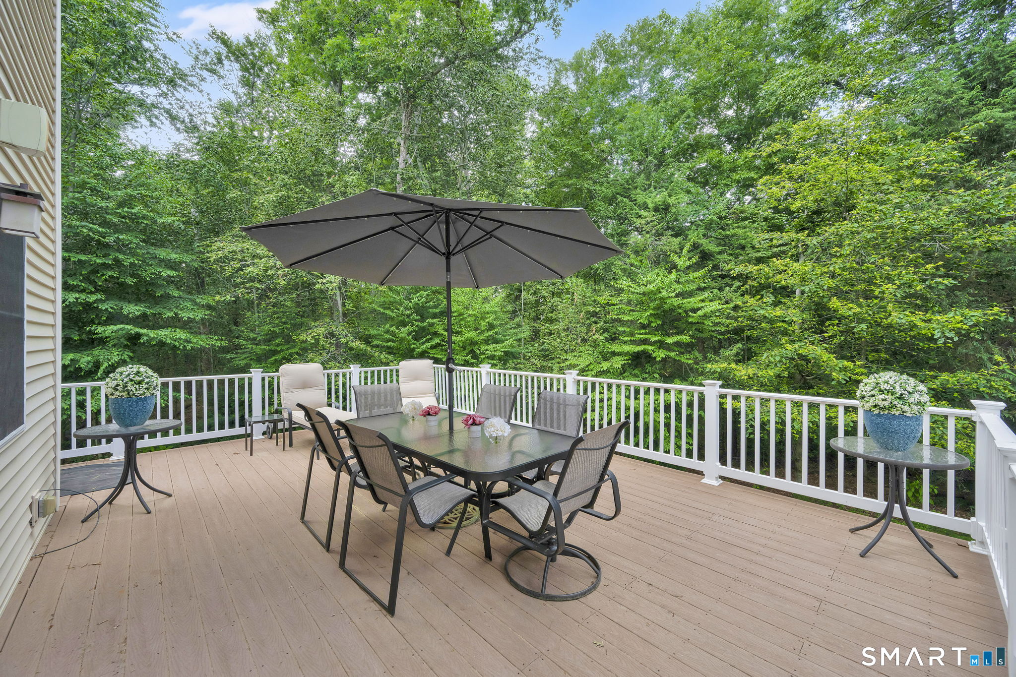 5 Edwards Way Bloomfield, CT 06002 - Photo 5 of 40 The sizable Trex deck opens off the Living / Dining and Kitchen area, creating a unique entertaining space overlooking the lush backyard.