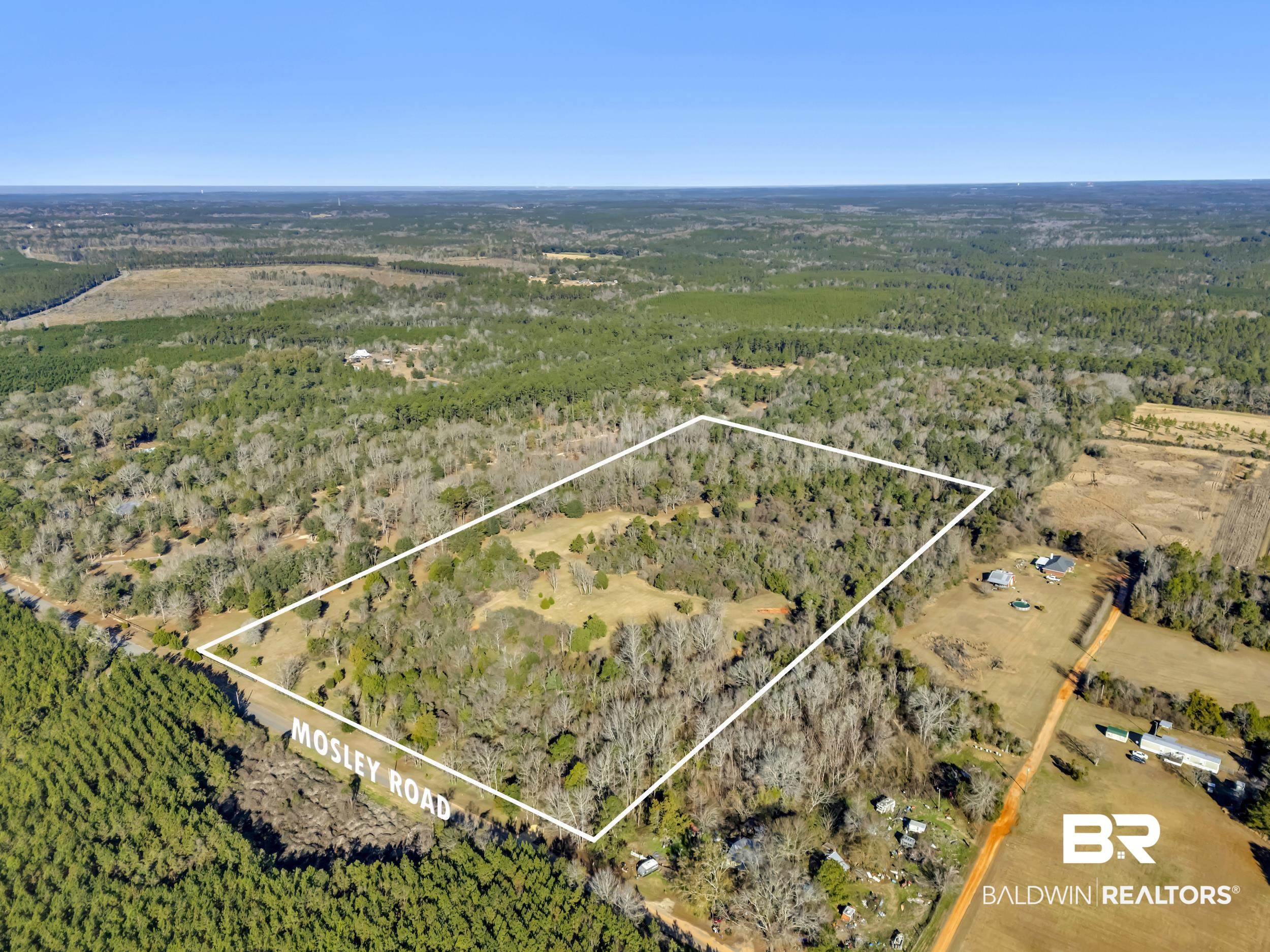 16691 Mosley Road Stapleton, AL 36578 - Photo 3 of 32 Aerial view of sparsely populated area featuring a heavily wooded area and property parcel outlined