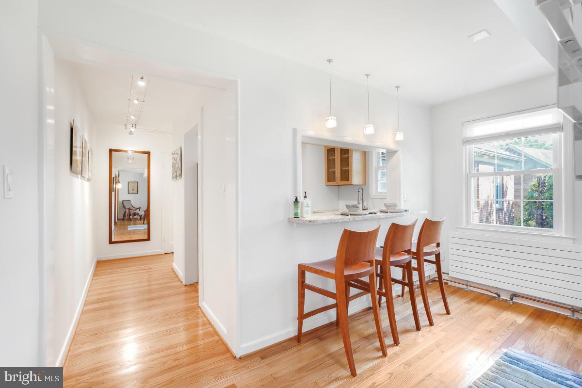 8335 Grubb Road, Unit 203 Silver Spring, MD 20910 - Photo 11 of 29 a view of a room with furniture and wooden floor