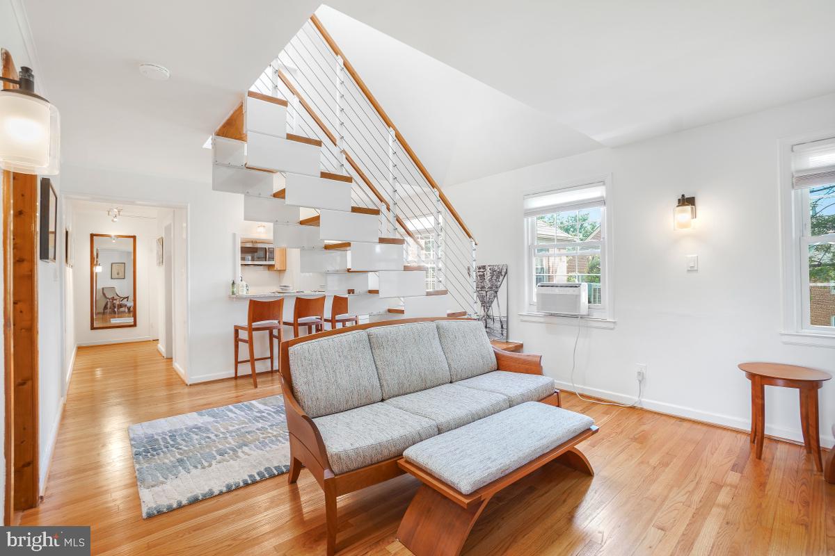 8335 Grubb Road, Unit 203 Silver Spring, MD 20910 - Photo 13 of 29 a living room with furniture and wooden floor