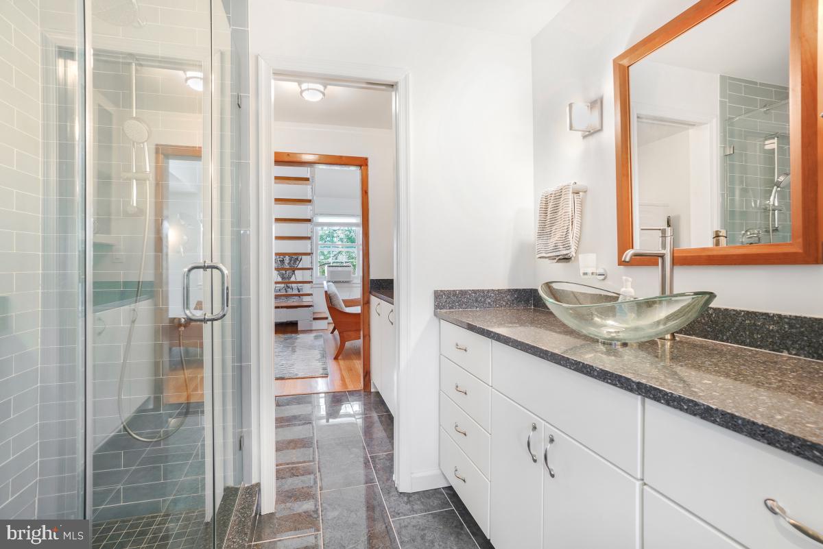 8335 Grubb Road, Unit 203 Silver Spring, MD 20910 - Photo 17 of 29 a bathroom with a granite countertop sink and a mirror