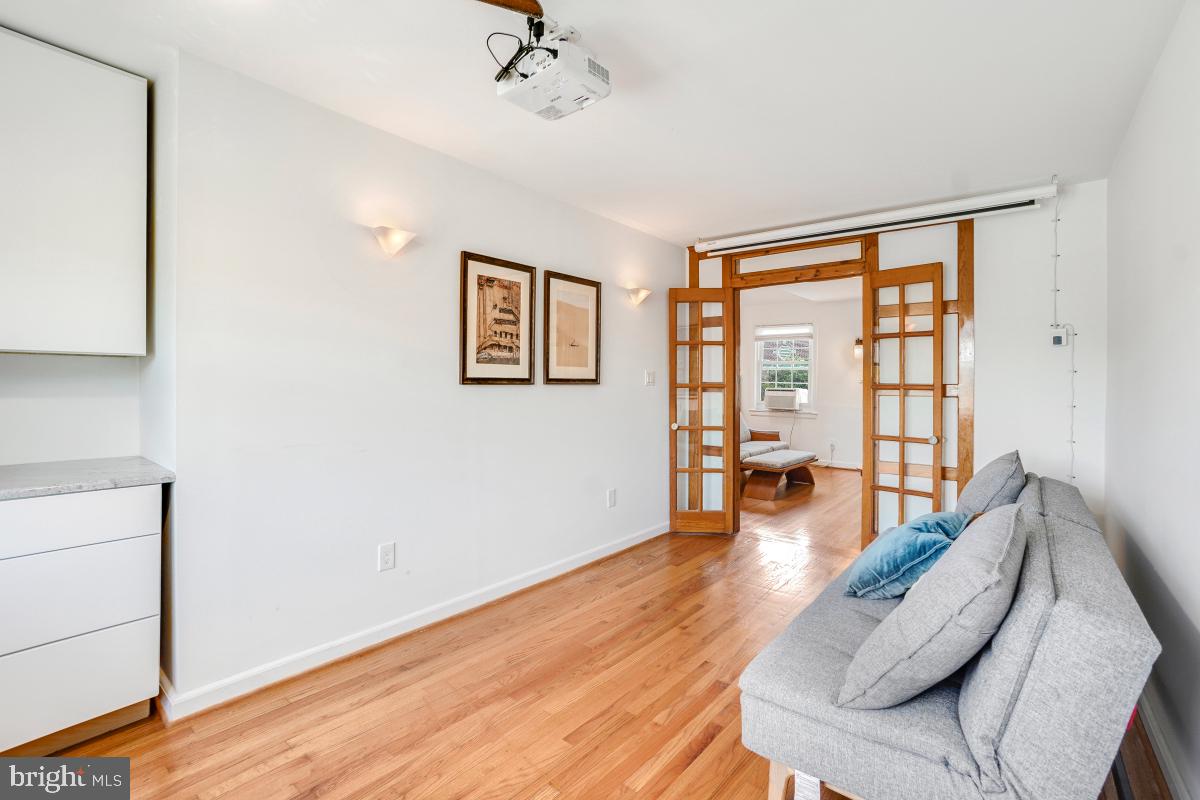 8335 Grubb Road, Unit 203 Silver Spring, MD 20910 - Photo 19 of 29 a living room with furniture and wooden floor