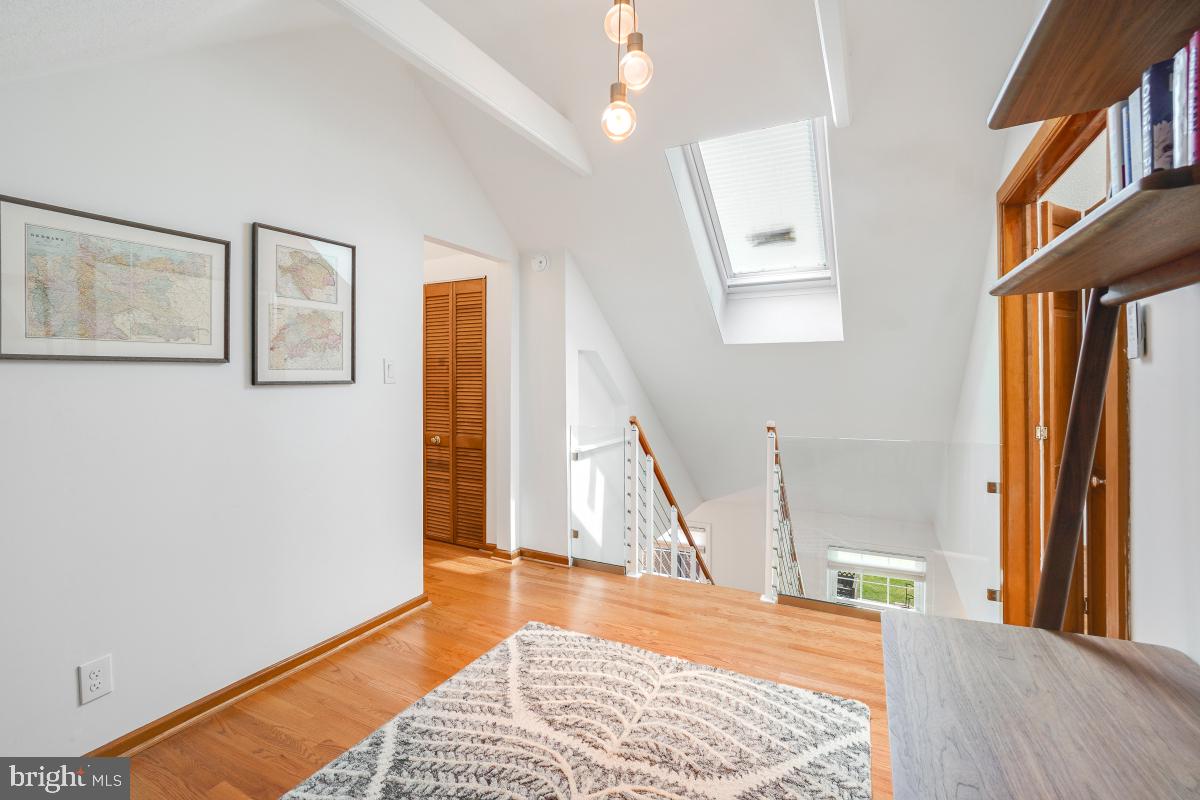 8335 Grubb Road, Unit 203 Silver Spring, MD 20910 - Photo 22 of 29 a view of a bedroom with wooden floor and a window
