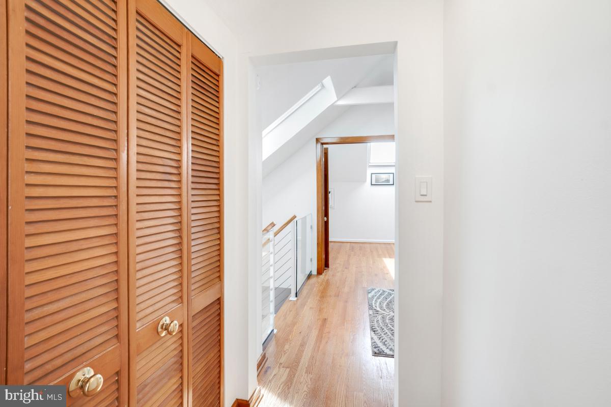 8335 Grubb Road, Unit 203 Silver Spring, MD 20910 - Photo 24 of 29 a view of a hallway with wooden floor and staircase