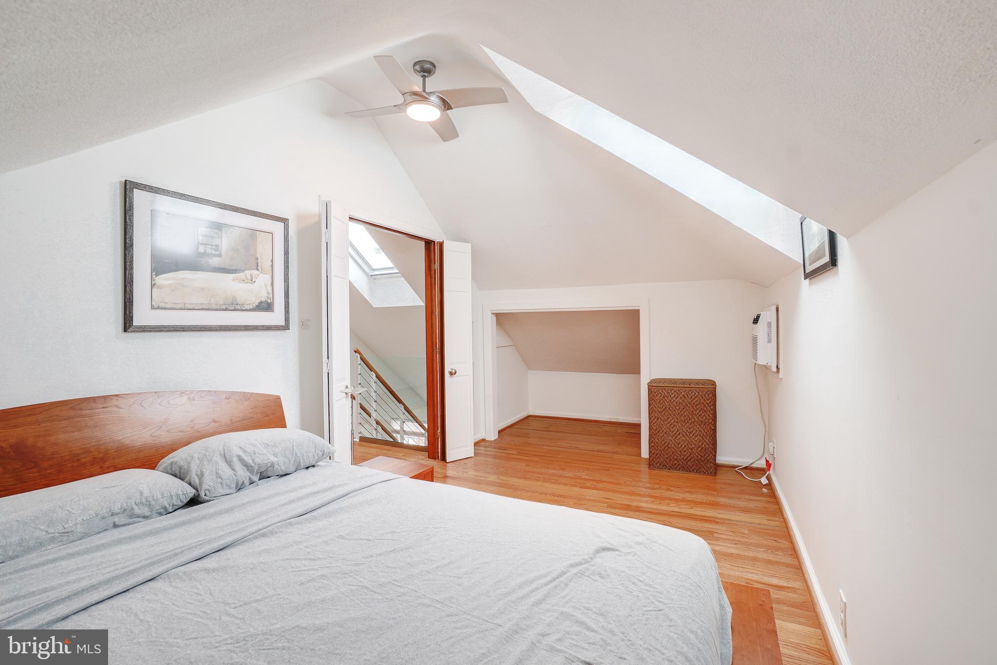 8335 Grubb Road, Unit 203 Silver Spring, MD 20910 - Photo 25 of 29 a bedroom with a bed and a chandelier