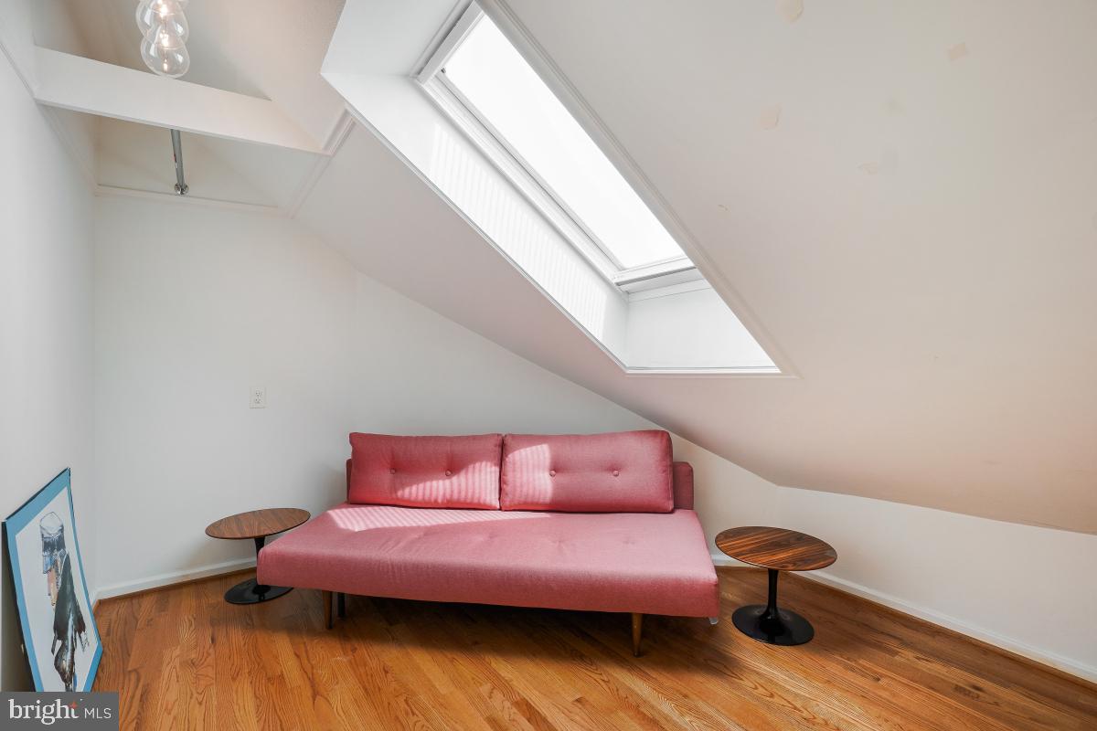 8335 Grubb Road, Unit 203 Silver Spring, MD 20910 - Photo 26 of 29 a living room with furniture and a wooden floor